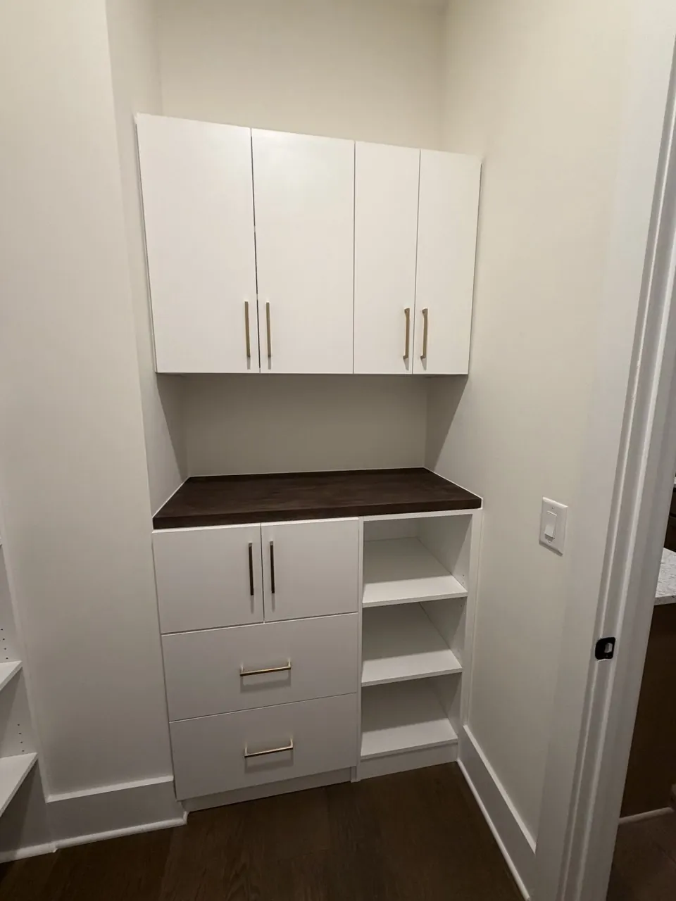 Built-in cabinetry with open shelving and a contrasting counter